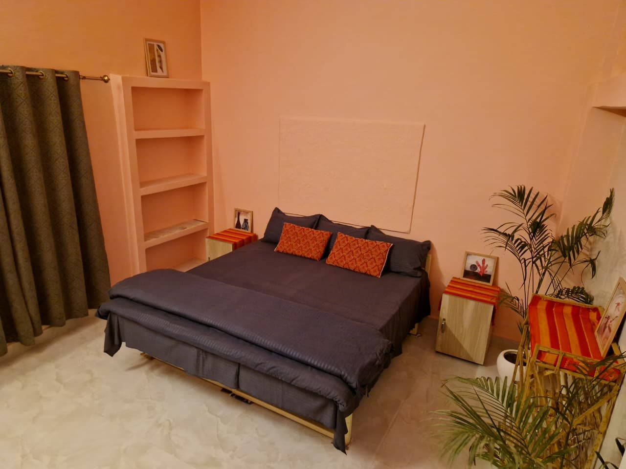 Retreat bedroom with shelving and curtain